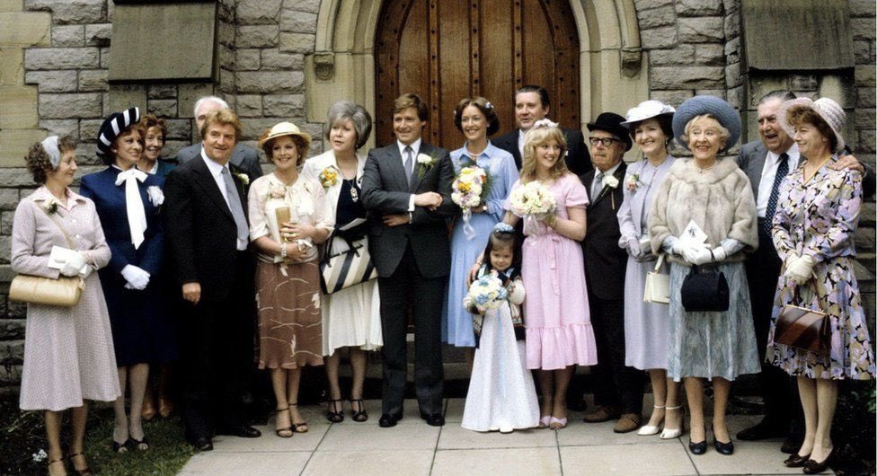 Wedding party gathered outside Holy Trinity Church for Ken and Deirdre Barlow's wedding, filmed for Coronation Street